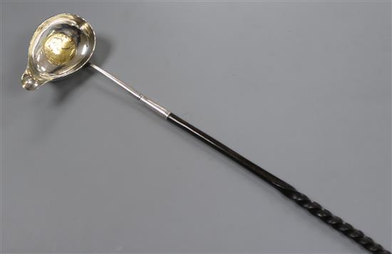 An 18th century white metal toddy ladle, the bowl inset with Queen Anne silver half crown, 38cm.